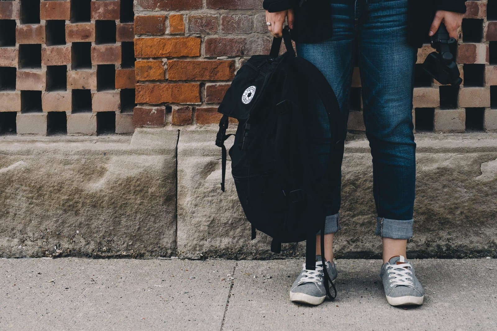 student holding backpack